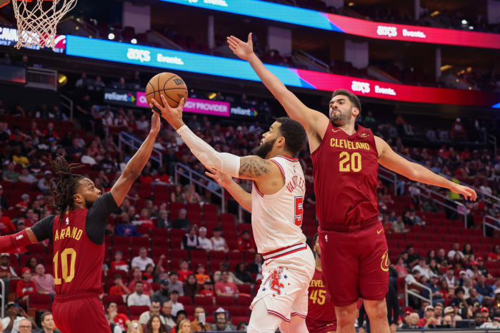 Mar 16, 2024; Houston, Texas, USA; Houston Rockets guard Fred VanVleet (5) splits the defense of Cleveland Cavaliers guard Darius Garland (10) and forward Georges Niang (20) in the first quarter at Toyota Center. Mandatory Credit: Thomas Shea-USA TODAY Sports